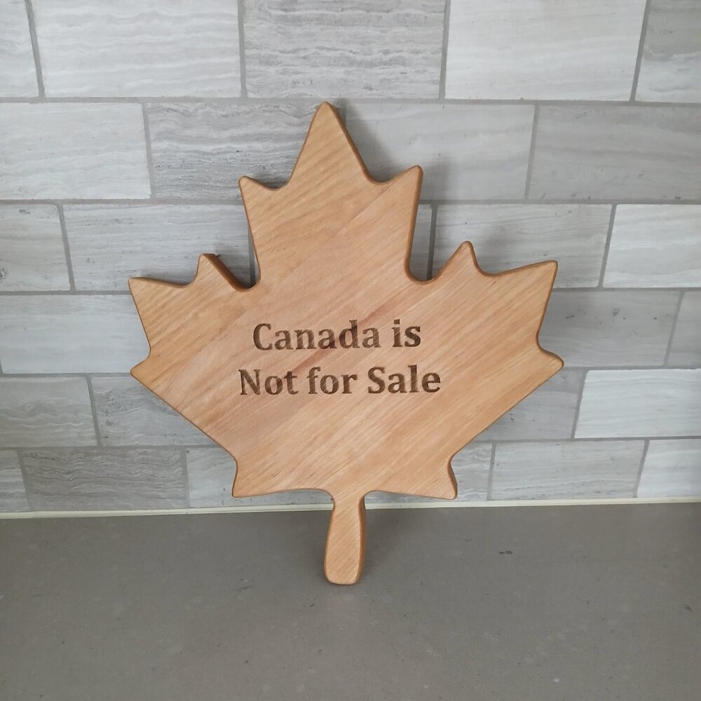 Charcuterie/Cutting Board in maple leaf shape with "Canada is Not for Sale"